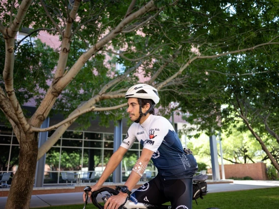 Man riding a bike with sticker on arm