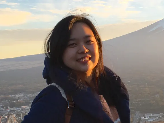 Yu Jung Chen smiling for photo with mountain in background