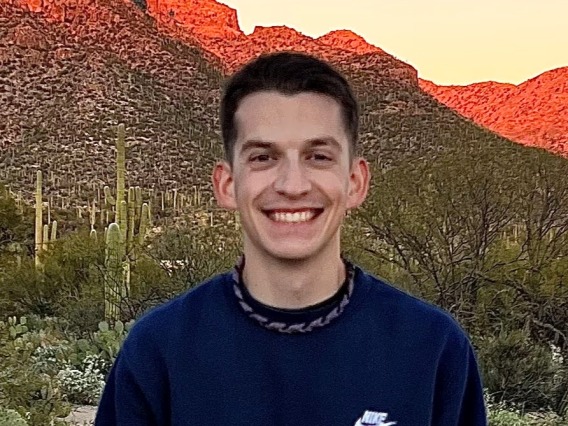 Derek Resio posing for photo in front of Arizona mountain ranges