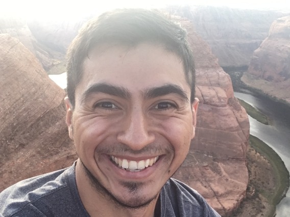 Cesar Medina smiling for photo in front of Horseshoe Bend in Arizona