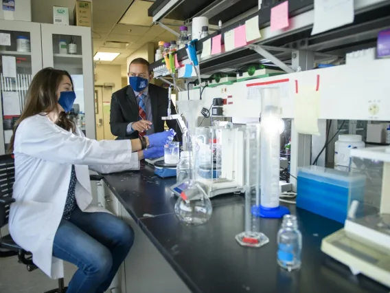 Two UArizona researchers working in a lab