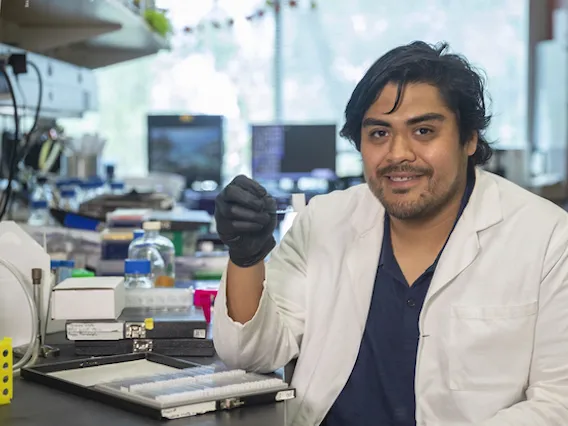 Researcher holding up a microscope slide