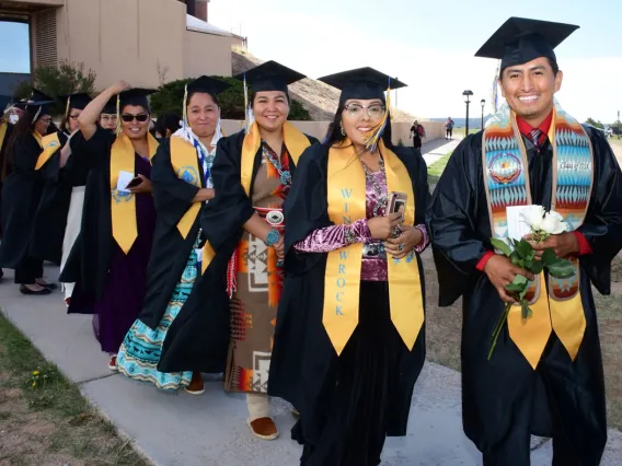 Tribal students posing for photo in their caps and gowns