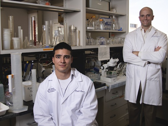 Two researchers posing for photo in lab