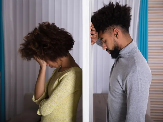 Distressed couple separated by a wall