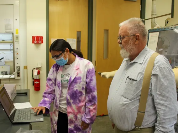 Two scientists working on a computer in a lab