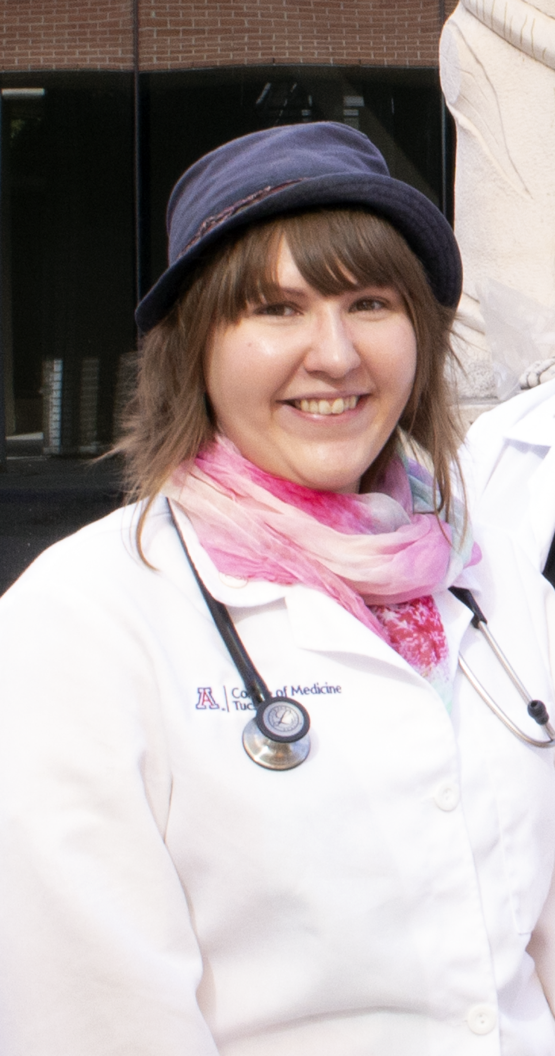 Britt Gratreak smiling for photo, wearing white lab coat