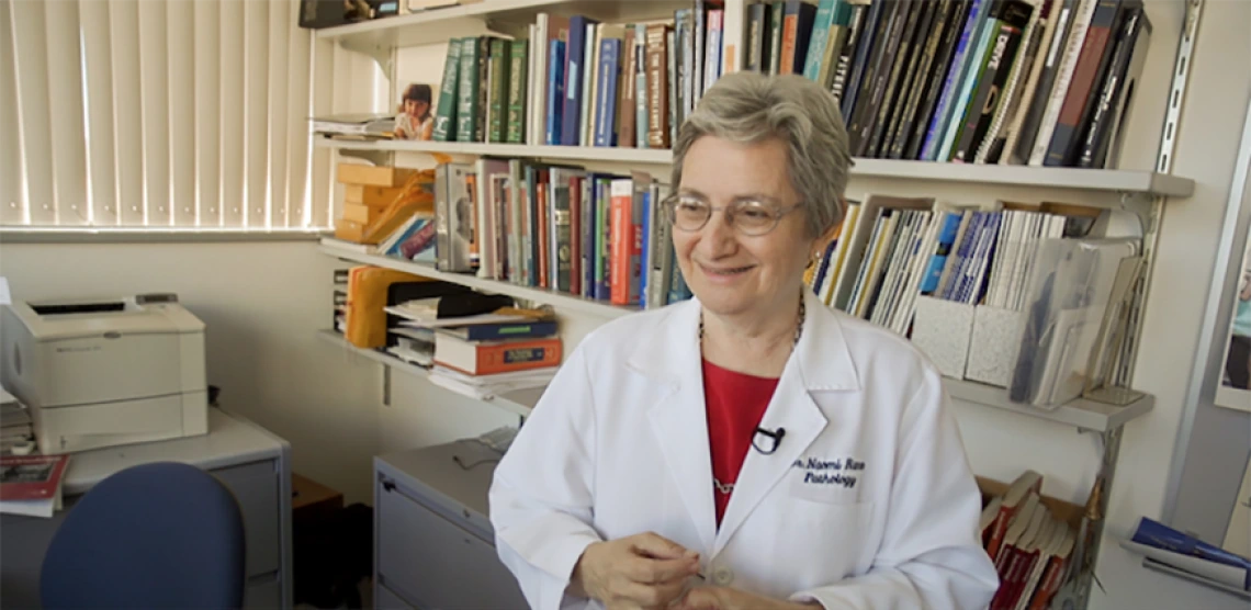 Scientist smiling for photo in her office