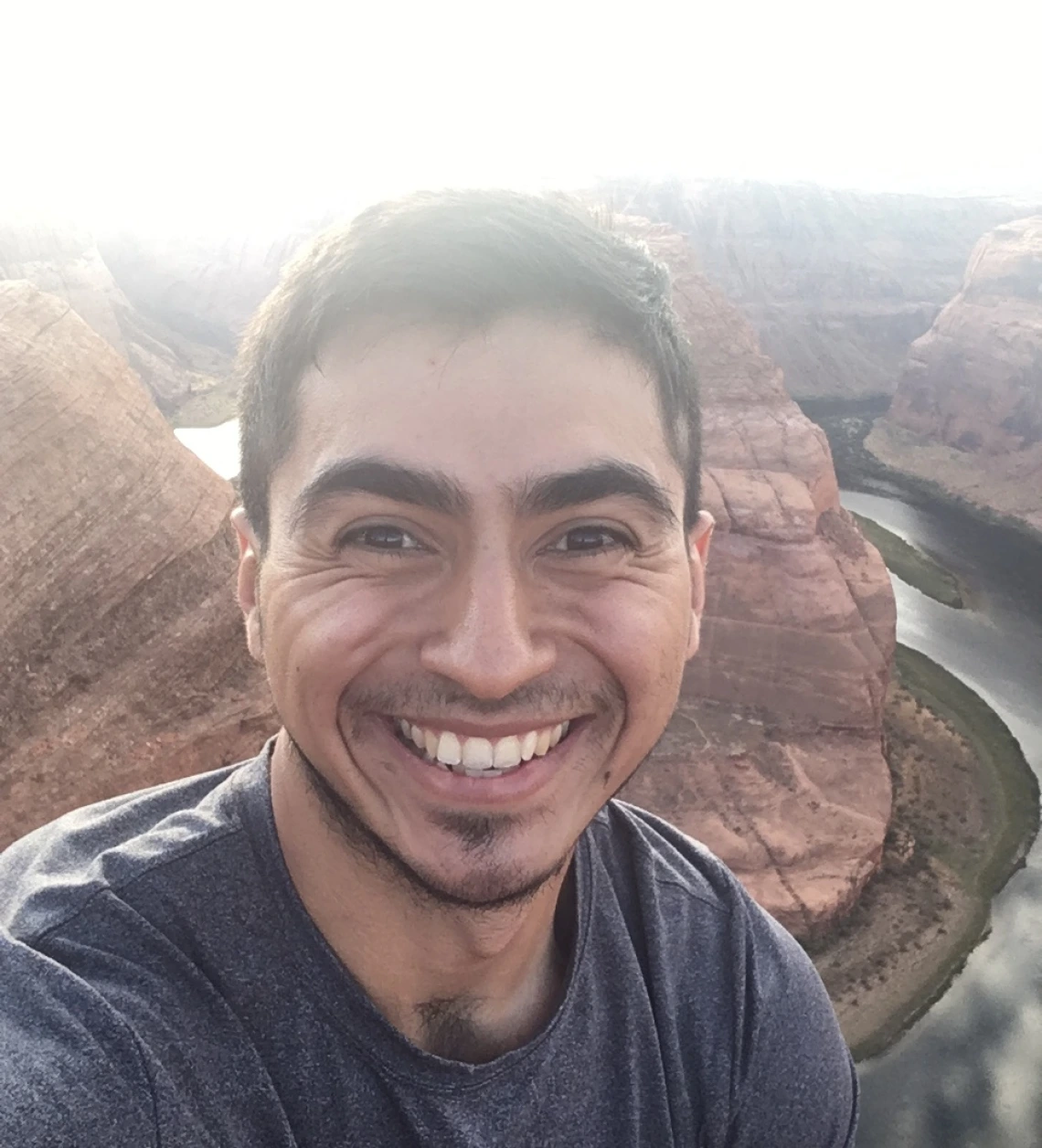 Cesar Medina smiling for photo in front of Horseshoe Bend in Arizona