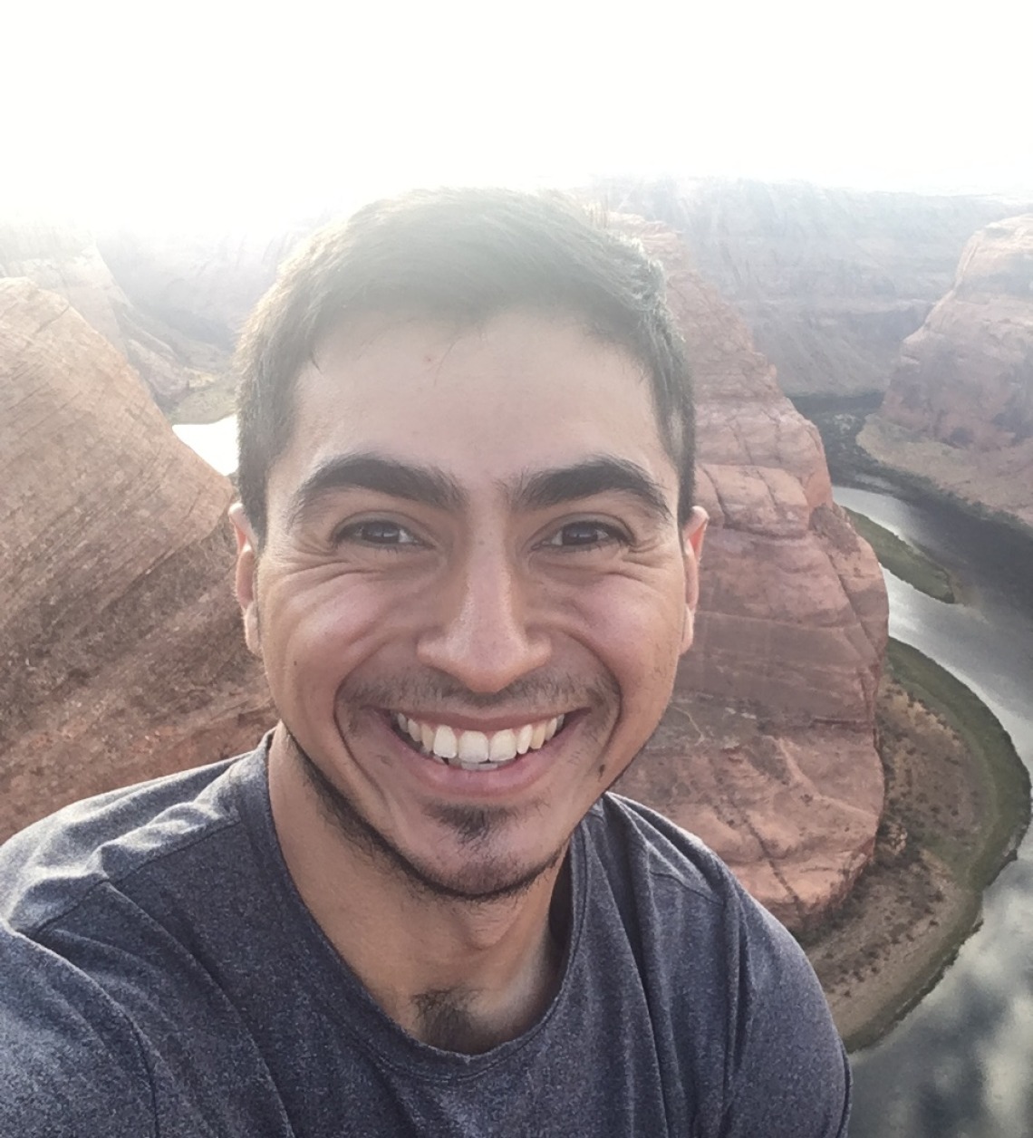Cesar Medina smiling for photo in front of Horseshoe Bend in Arizona