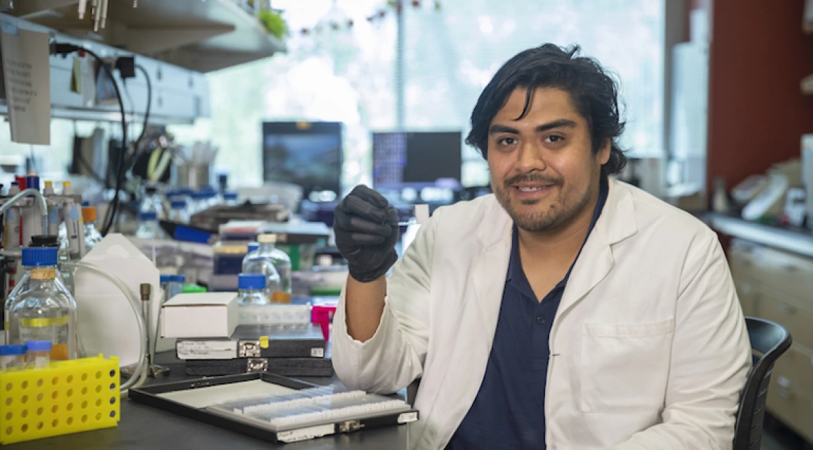 Researcher holding up a microscope slide