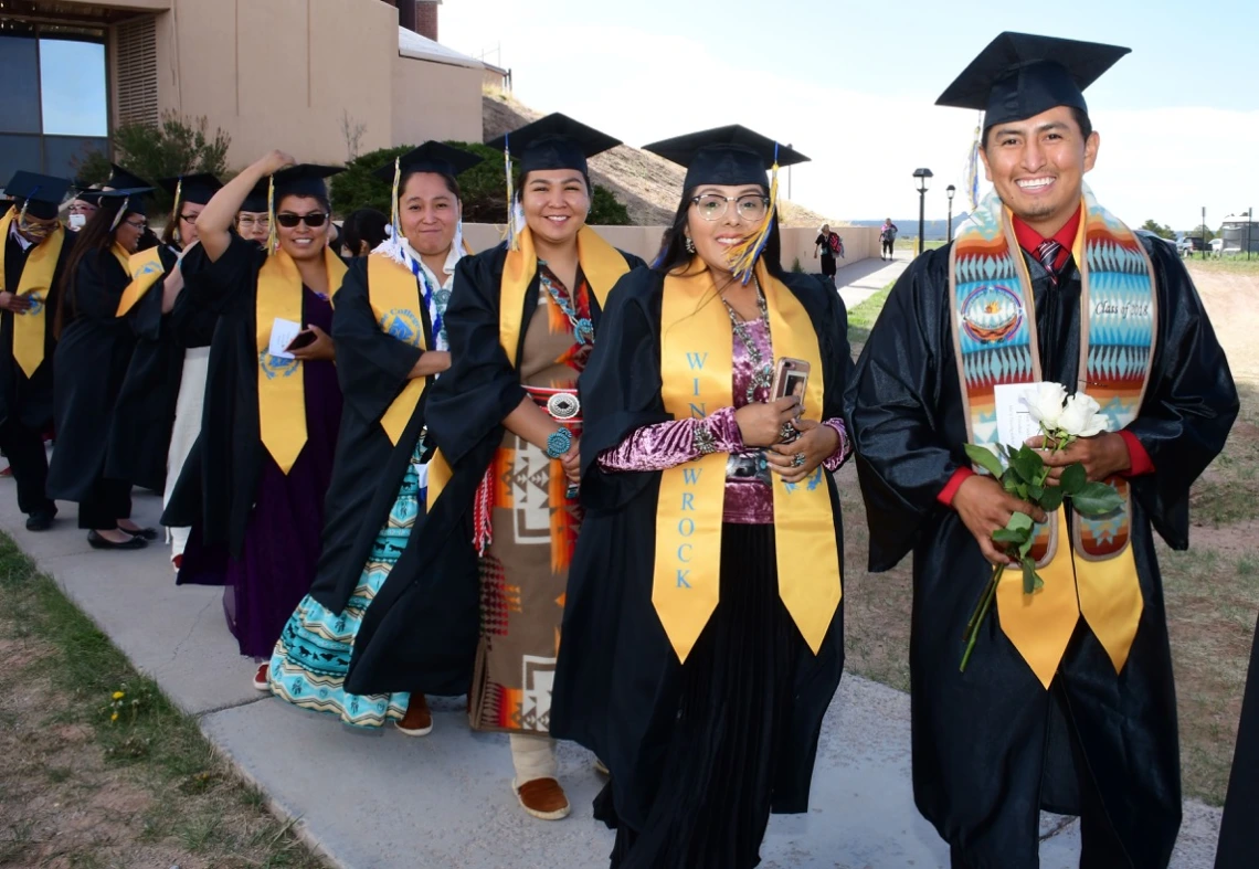 Tribal students posing for photo in their caps and gowns