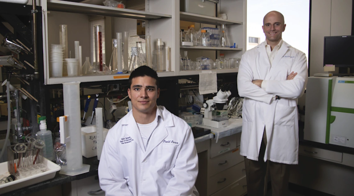 Two researchers posing for photo in lab