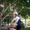 Man riding a bike with sticker on arm